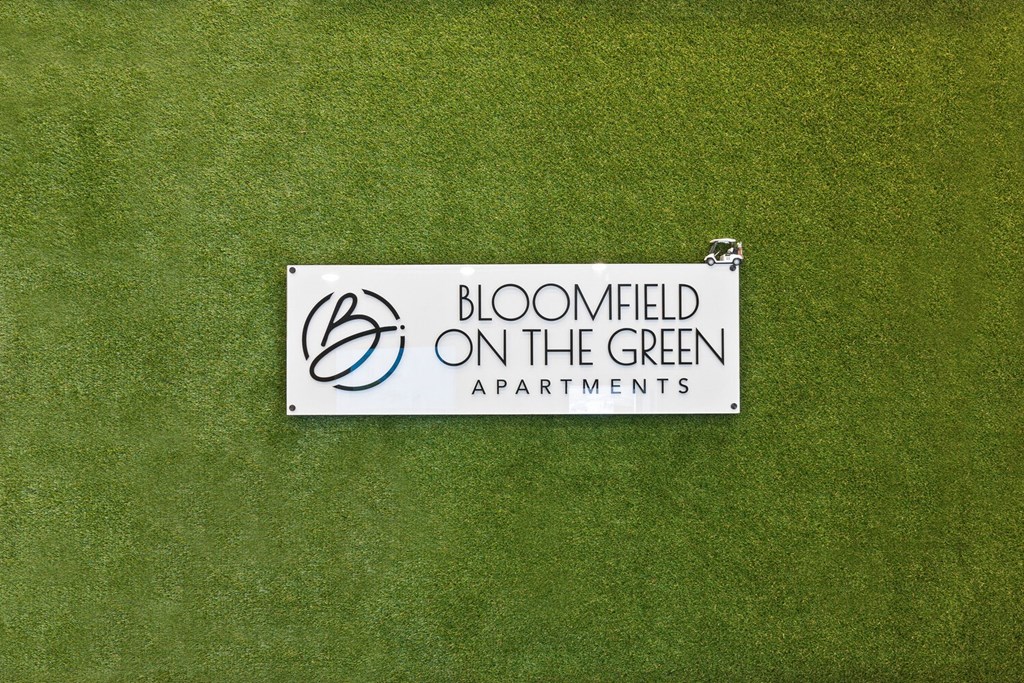 a sign for bloomfield on the green apartments