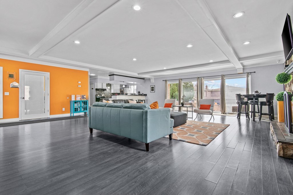 a living room with a couch and a table with chairs