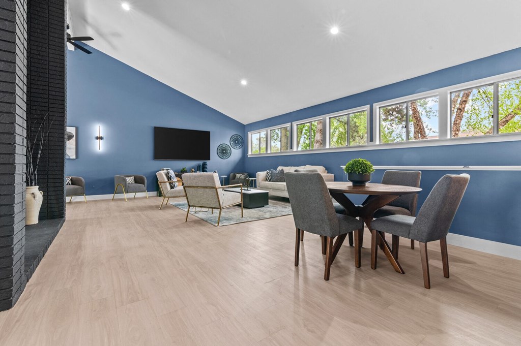 a living room with blue walls and a table and chairs