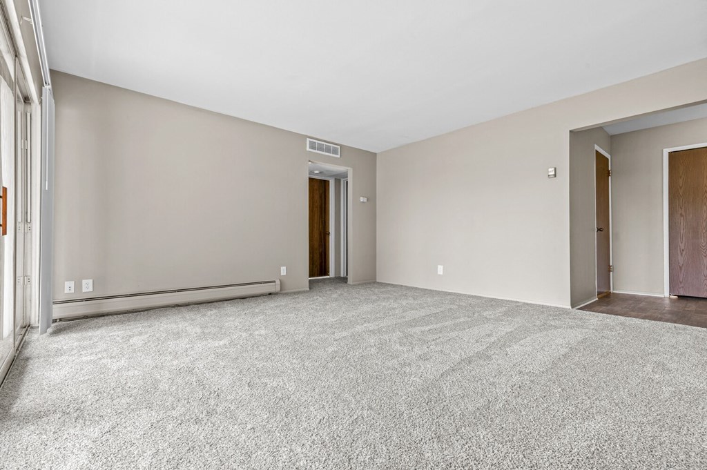 a bedroom with gray walls and a carpeted floor