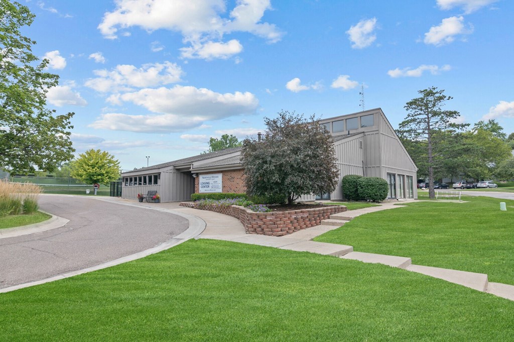 a large building with a grassy area in front of it