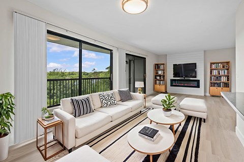 A living room with a white couch and a coffee table.