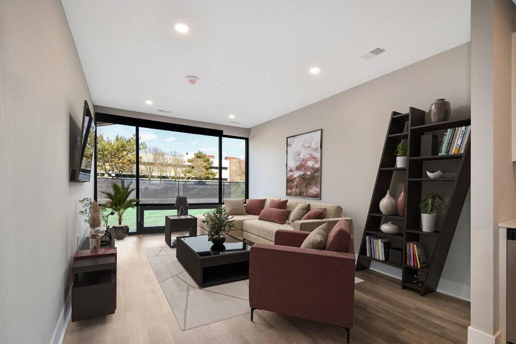 A modern living room with a large window and a view of the outdoors.