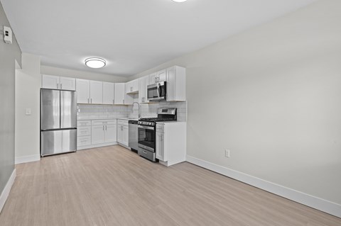 A kitchen with white cabinets and stainless steel appliances.
