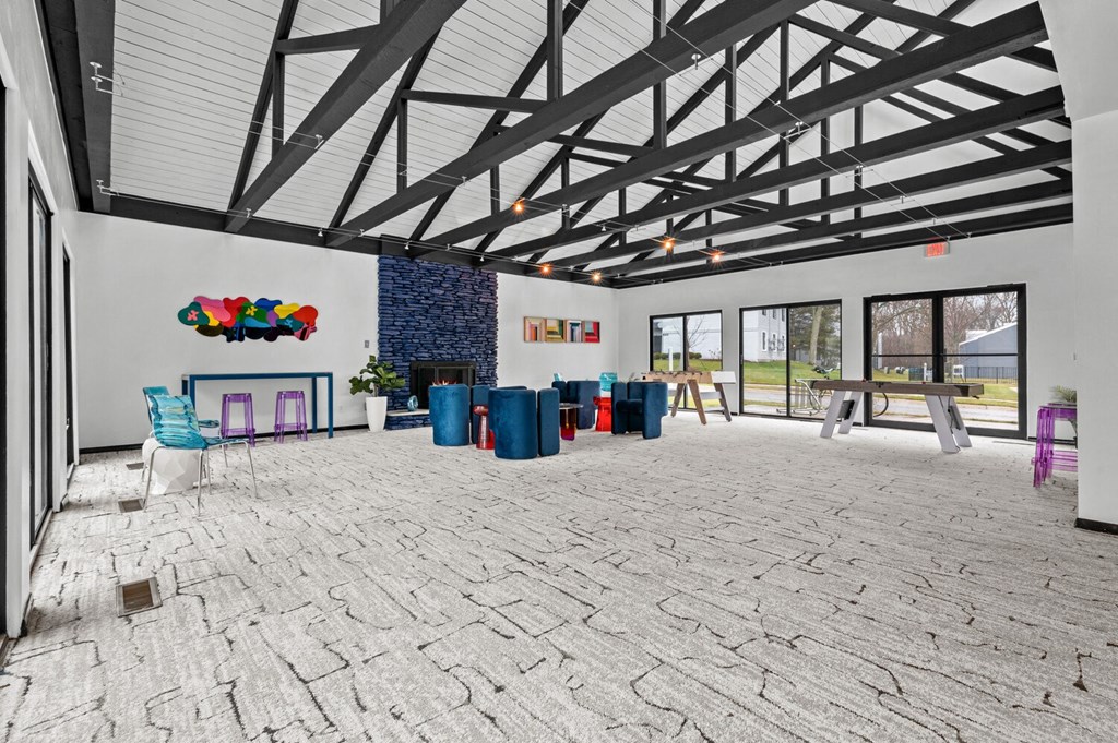 the lobby of a building with a brick floor and a large open room with chairs