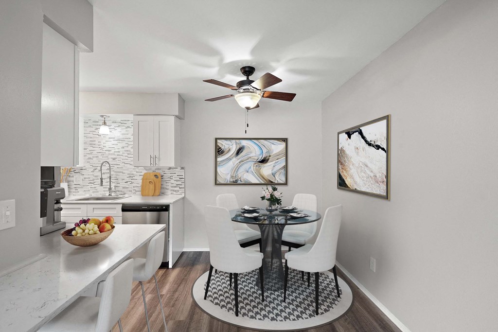 a dining room with a table and a ceiling fan