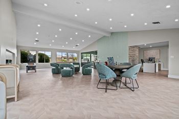 a large living room with a table and chairs