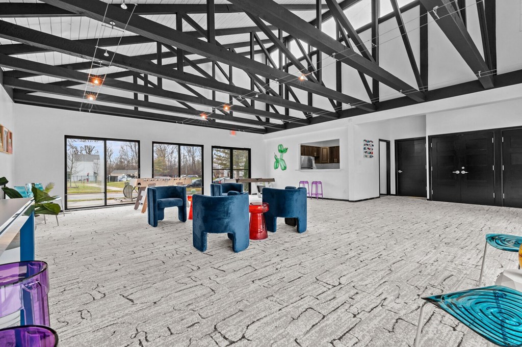 a large room with tables and chairs and glass doors
