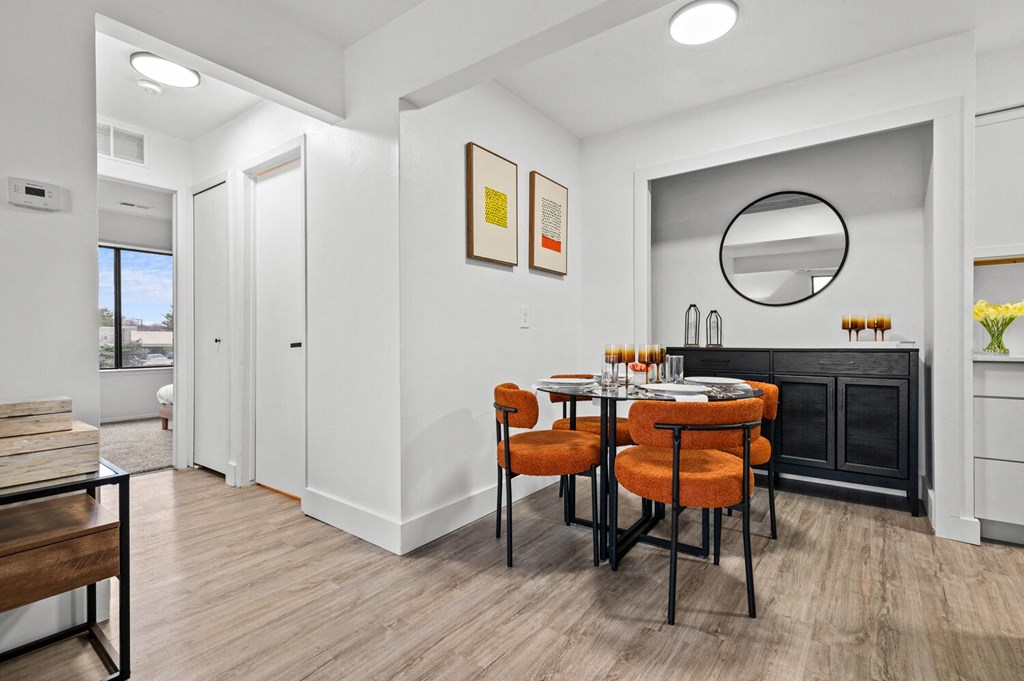 a dining room with a table and chairs and a mirror  at Park On Canal Apartments, Michigan