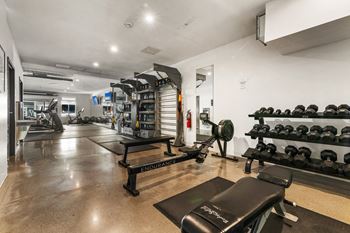 a workout room with weights and other exercise equipment