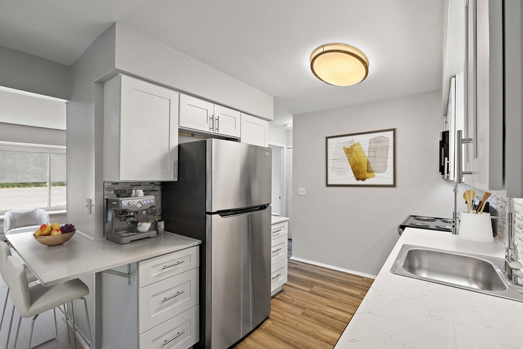 a kitchen with stainless steel appliances and a white counter top
