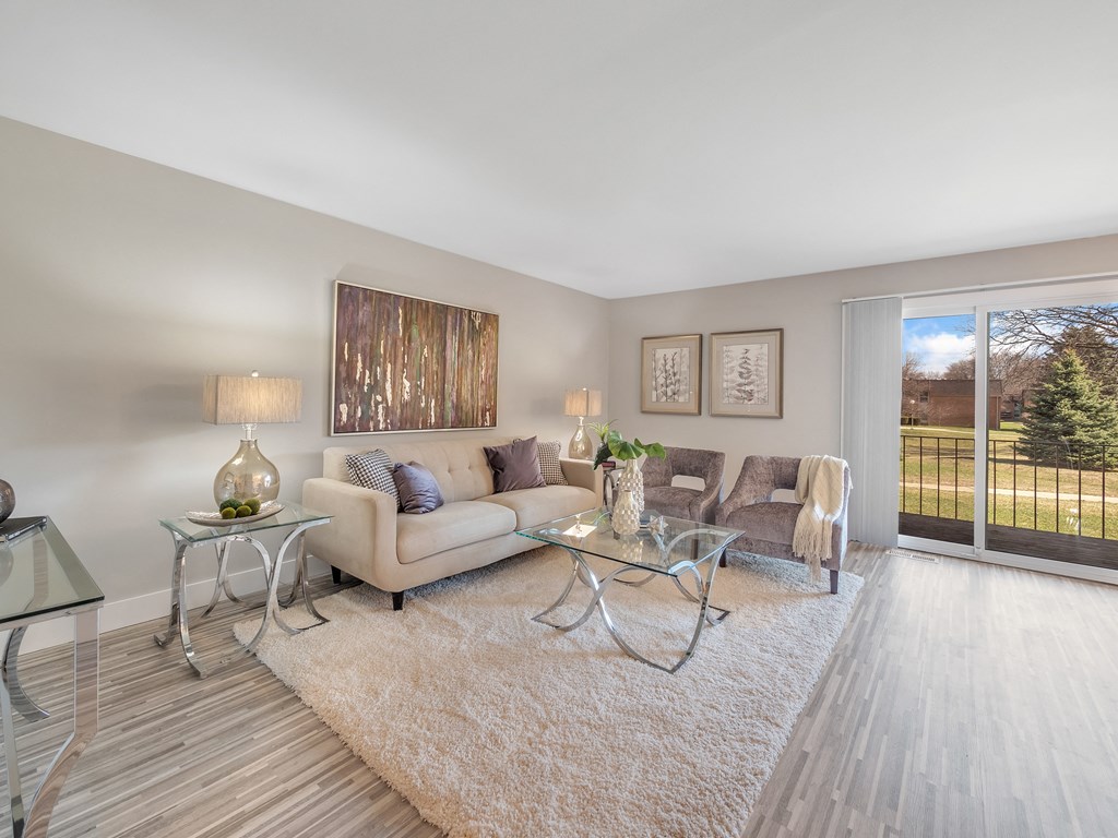 Living Room With Balcony at Rochester Club Apartments - Rochester, MI, Rochester Hills, 48306