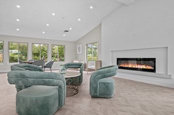 a living room with couches and chairs and a fireplace