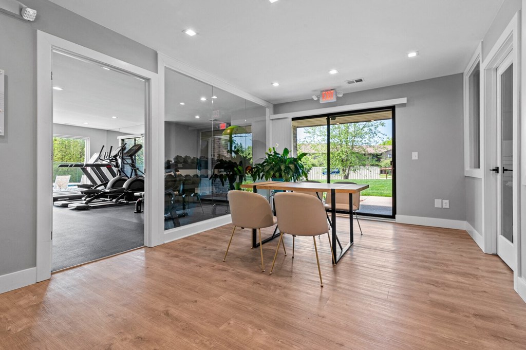 a dining room with a table and chairs and sliding glass doors