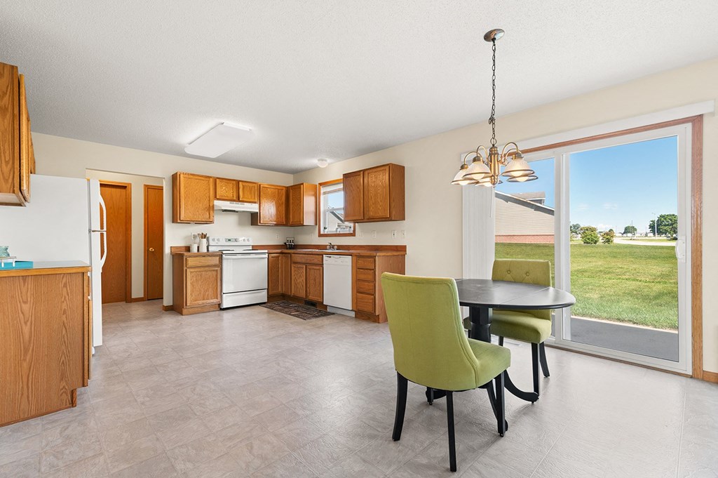 a kitchen with a table and chairs and a window