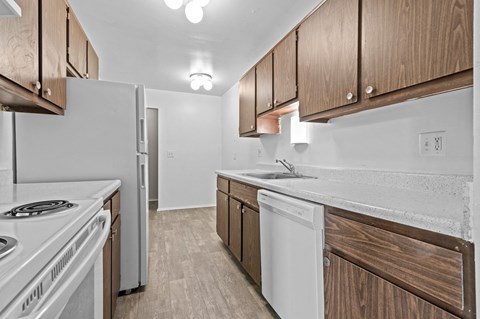 a kitchen with wooden cabinets and white appliances