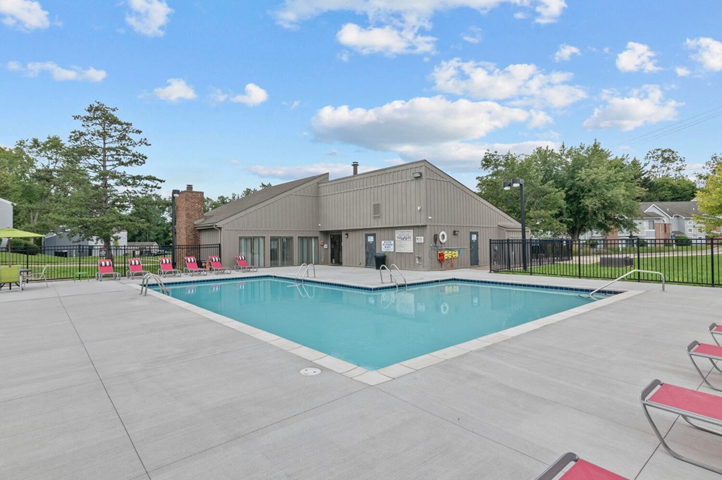 a swimming pool with a building in the background