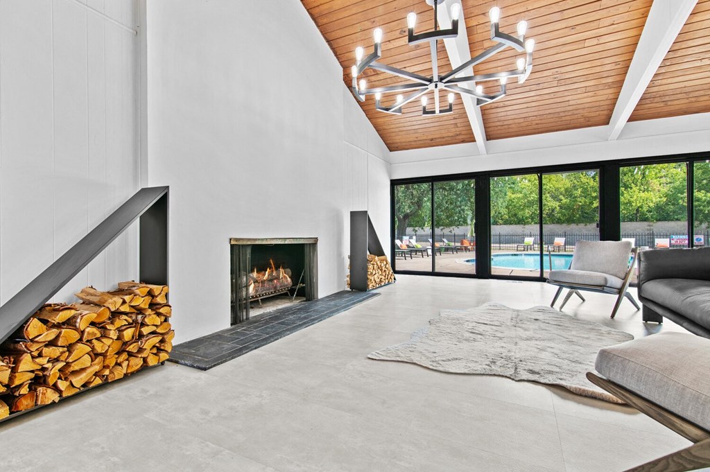 a living room with a fireplace and sliding glass doors