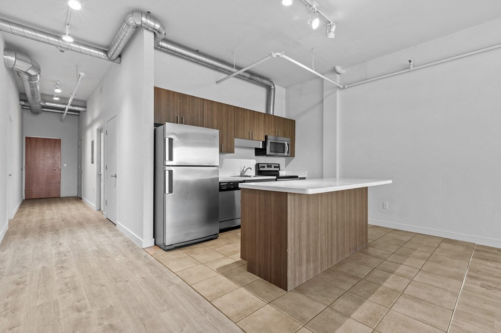 a kitchen with an island and stainless steel appliances