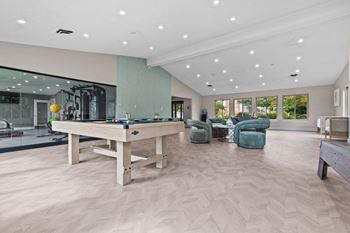 a large game room with a pool table and chairs