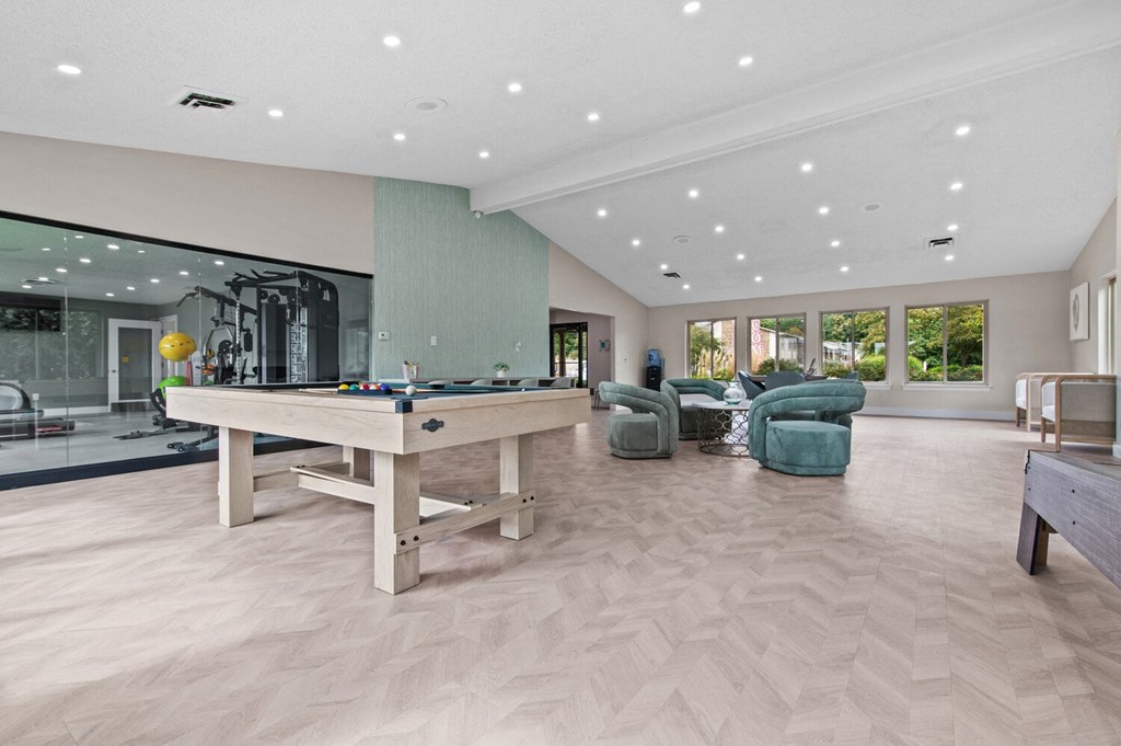 a large game room with a pool table and chairs at Edge At Farmington Hills - Farmington Hills, MI, Michigan