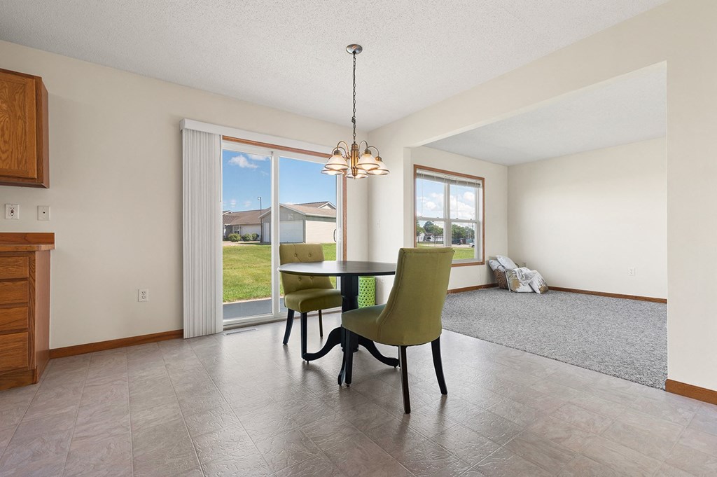 a dining room with a table and chairs and a window