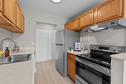A kitchen with wooden cabinets and stainless steel appliances.