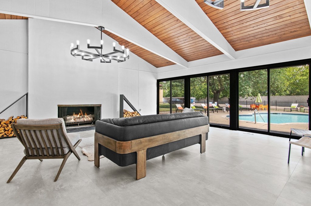 a living room with a couch and chairs in front of a fireplace