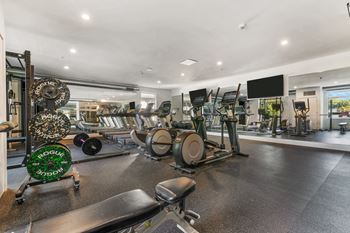 a room filled with lots of different types of exercise equipment