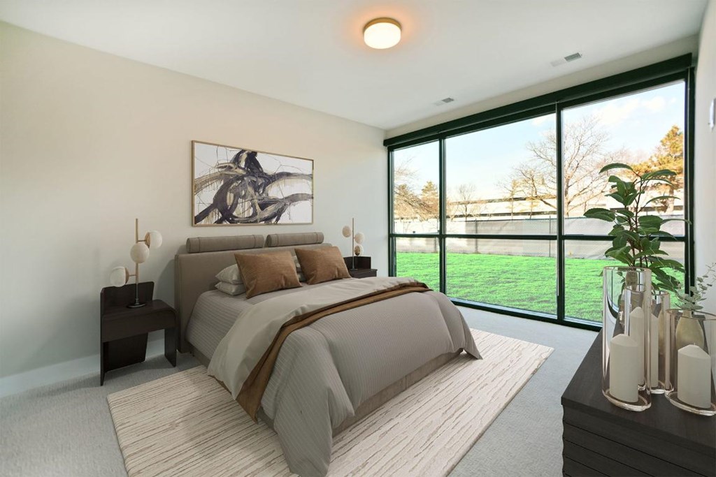 A bedroom with a large bed and a painting on the wall.