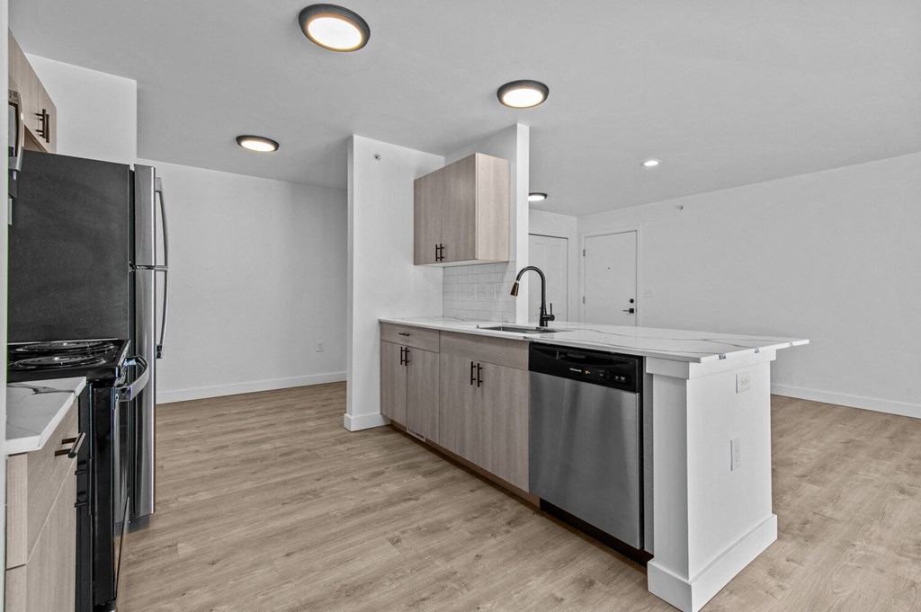 a renovated kitchen with an island and stainless steel appliances