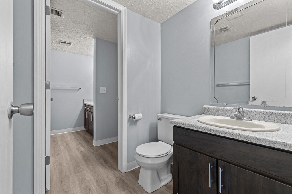 an empty bathroom with a toilet sink and mirror