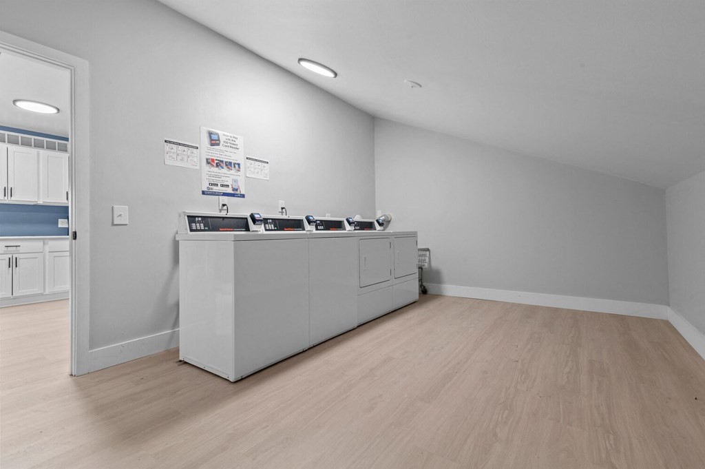 a room with a counter and a refrigerator in the middle of it