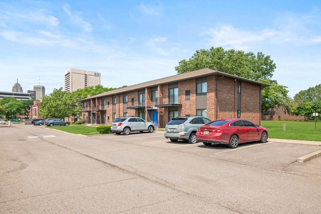 a brick apartment building with a parking lot in front of it at Lafayette Park Place, Detroit, MI, 48207