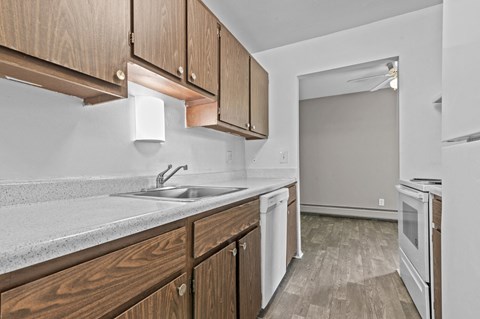 a kitchen with wooden cabinets and white appliances