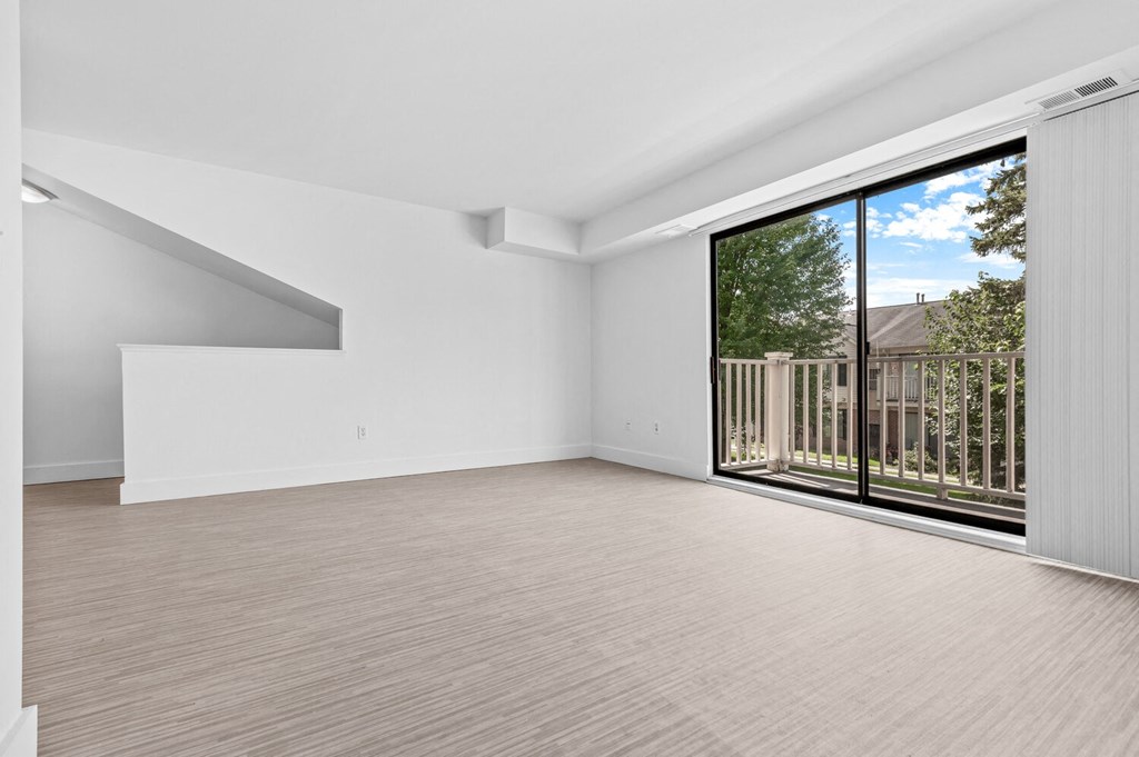 a bedroom with a large window and a balcony