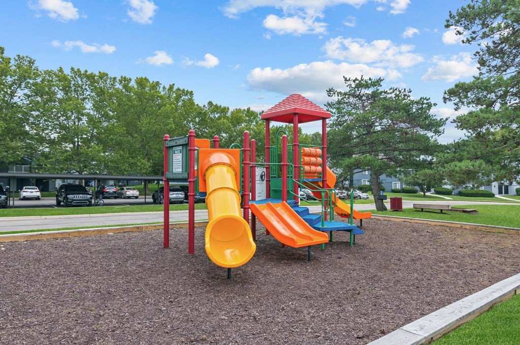 a playground with two slides and a climbing structure