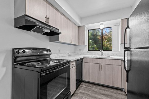 a kitchen with gray cabinets and a black stove top oven