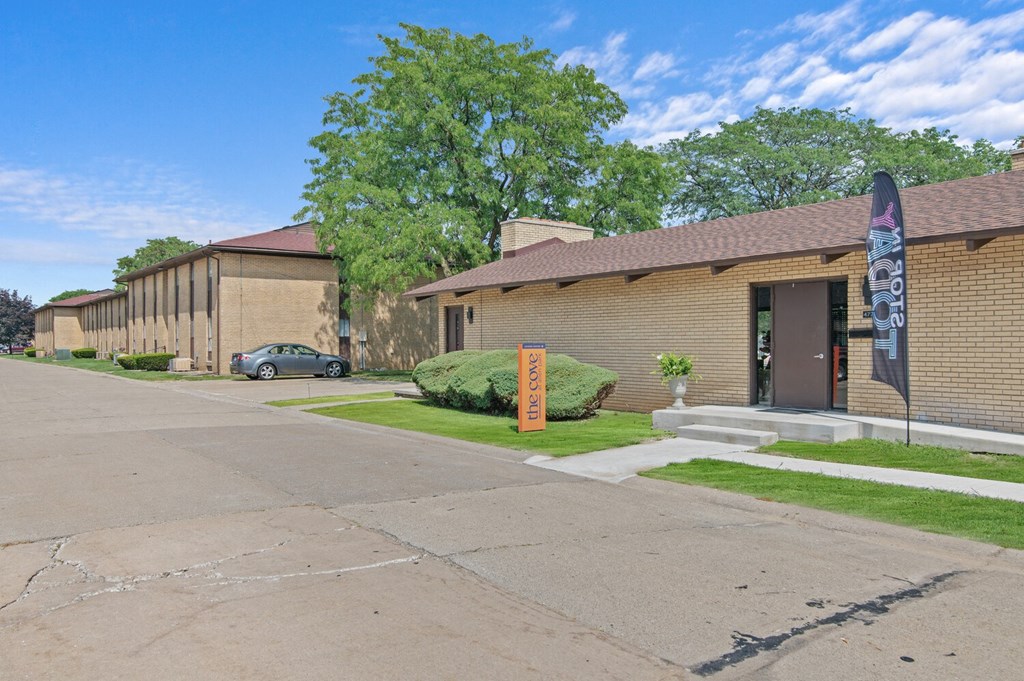 a brick building with a car parked in front of it