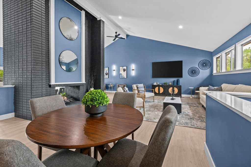 a living room with blue walls and a table with chairs