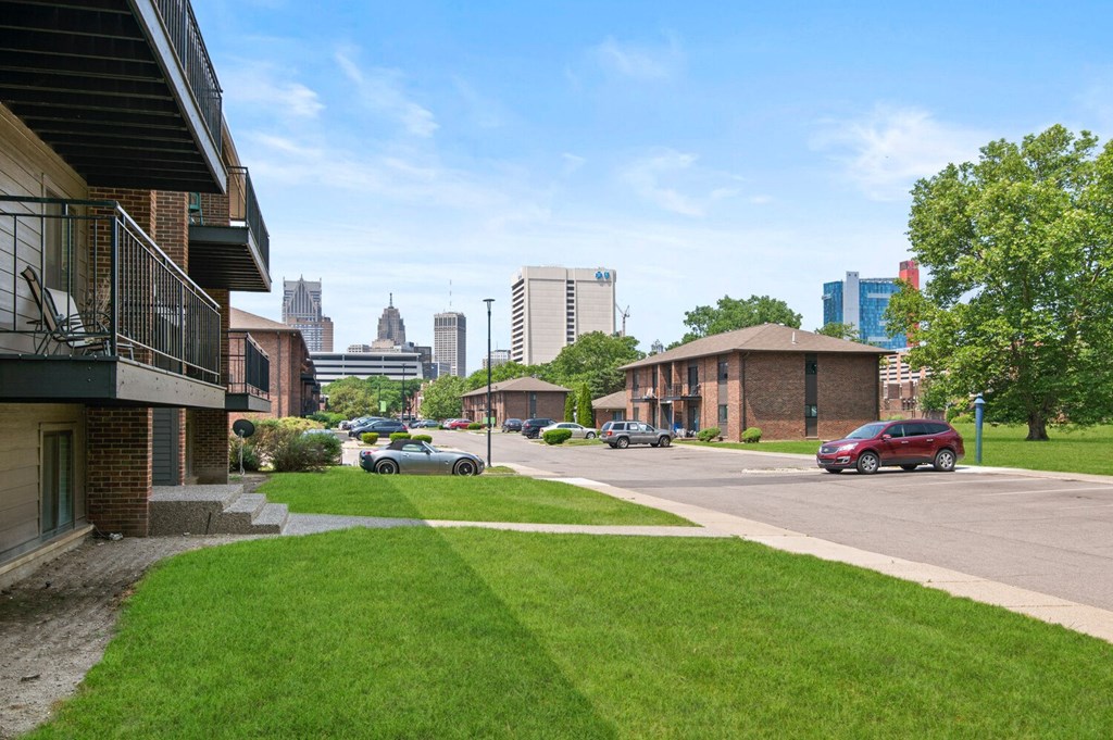 a lawn in front of a building with a view of the city in the background at Lafayette Park Place, Detroit, MI, Michigan