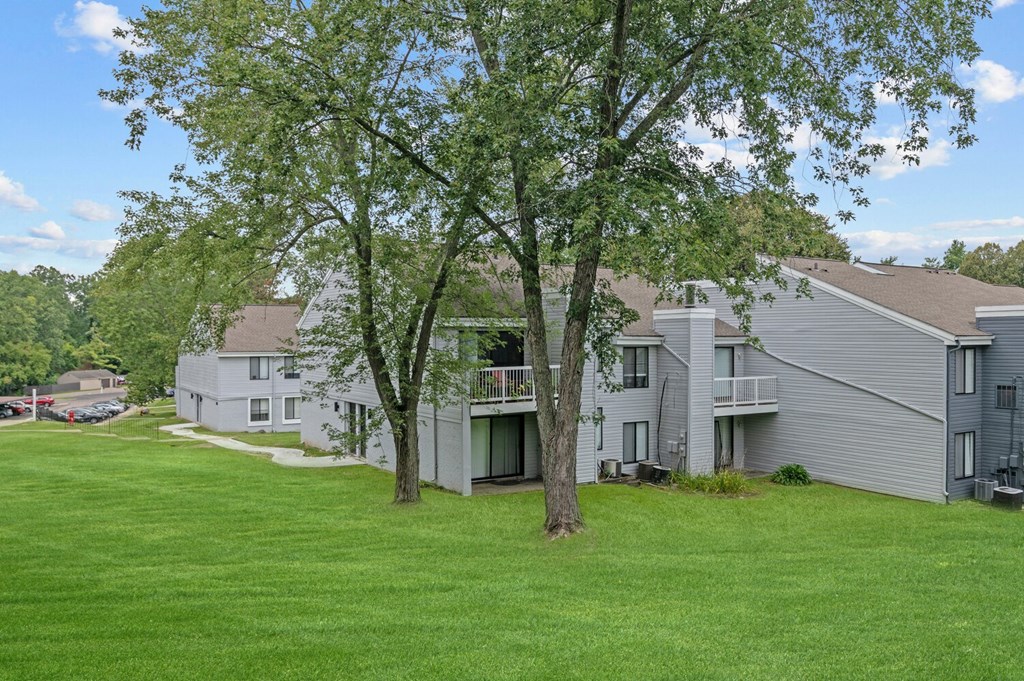 a view of the exterior of a building at the whispering winds apartments in pearland, tx