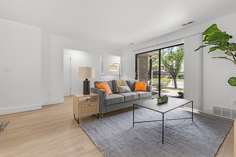 A living room with a grey couch and a coffee table.