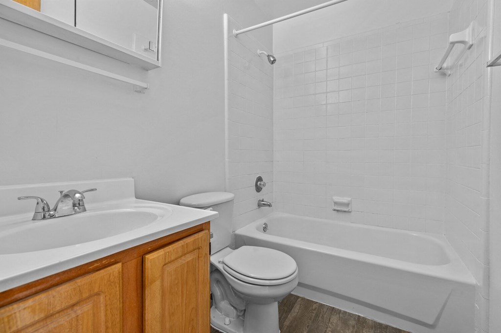 a bathroom with a sink toilet and a bath tub