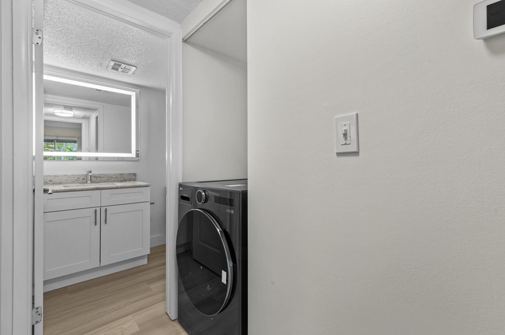 A washing machine is placed in a laundry room.