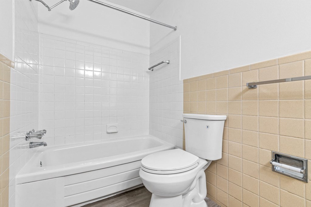 a bathroom with a tub and a toilet