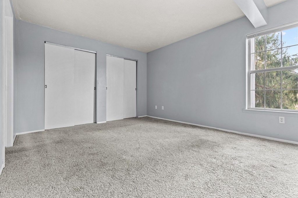 an empty room with a window and a door