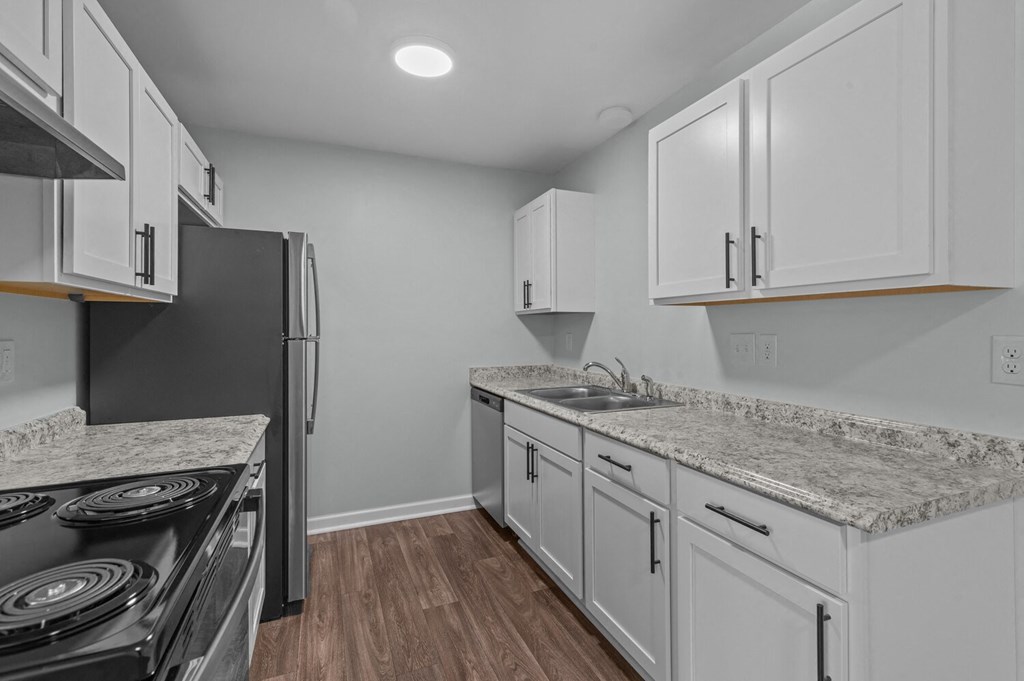 the kitchen in a new home with white cabinets and granite counter tops