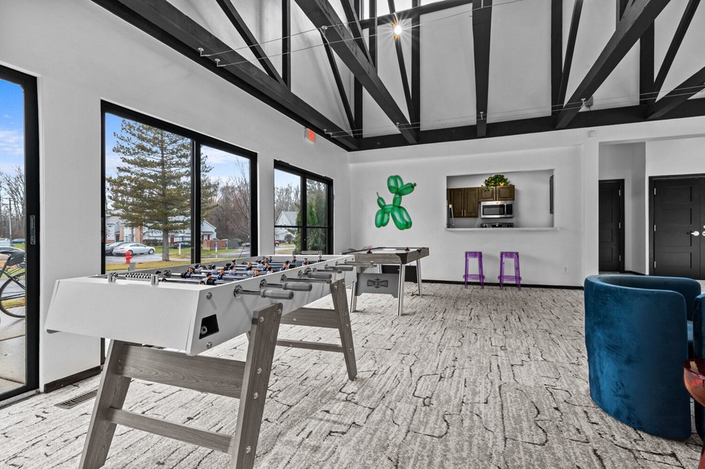 a game room with a foosball table and a large window