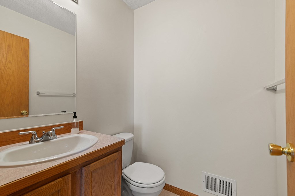 a bathroom with a sink and a toilet and a mirror